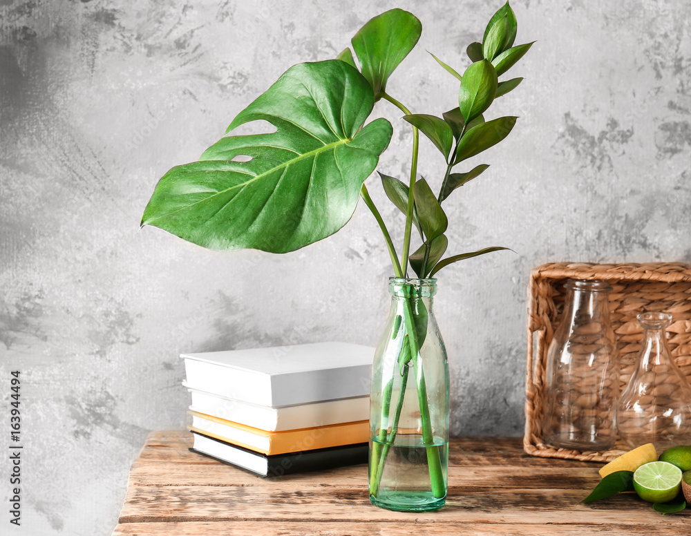 Marvelous composition with variety of tropical plants on wooden table