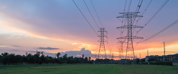 group silhouette of transmission towers (power tower, electricity pylon, steel lattice tower) at twi