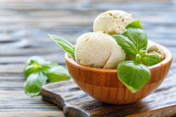 Fototapete - Basil homemade ice cream in a wooden bowl.
