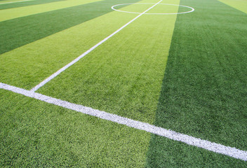 Photo of a green synthetic grass sports field with white line shot from above