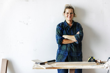 Wall Mural - Woman carpenter working on a wood