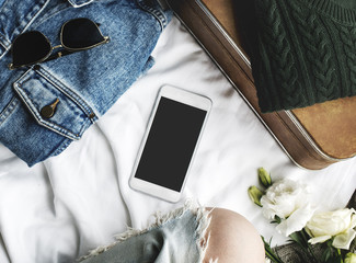 Lifestyle woman sitting with clothing and smart phone