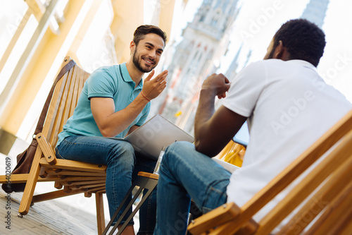 Fotografie, Obraz Cheerful ambitious man convincing his colleague