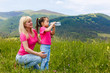 © Angelov - Mother and daughter drink water in the mountains