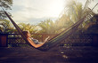 © soft_light - Young woman read a book in a hammock on the terrace.