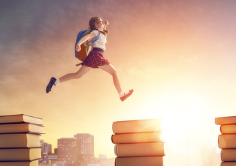 child running and jumping on books