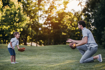 dad with son playing baseball