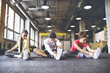 © Westend61 - Three young people stretching in gym