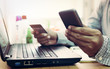 © surasaki - Businessman using laptop and mobile phone to online shopping.