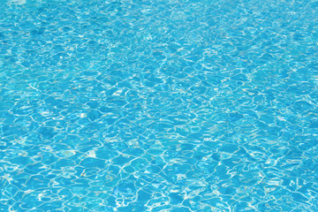 Blue and bright water surface and ripple wave in swimming pool