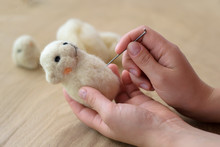 Process Of Felting A Toy From A Light Wool On A Wooden Background