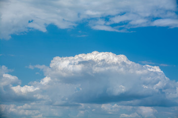 Wall Mural - White curly clouds in a blue sky. Sky background