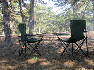 in the woods with two empty chairs.peace . holiday