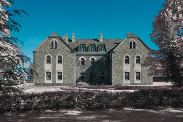 Wall Mural - Old stoned building in Cesis, Latvia. Infrared photography, color swapped process.