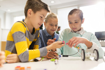 Wall Mural - happy children building robots at robotics school
