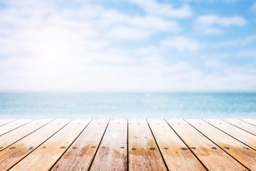 empty wooden table with party on beach blurred background in summer time.