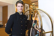 Young man in uniform serving in hotel