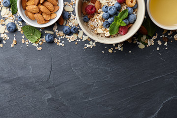 Wall Mural - Healthy cereal breakfast with seasonal berries, almonds, farm milk and honey