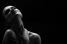 Black And White Shot Of Woman Posing Sensually Holding Head Up On Black Background, Monochrome
