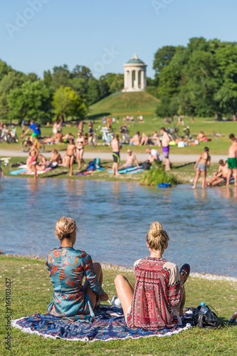 People Enjoying The Summer Sunbathing Swimming In River Izar And