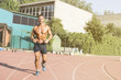 © Addoro - Handsome middle aged man running on a running track. Healthy middle-aged athlete smiling during morning run. Shirtless man running.