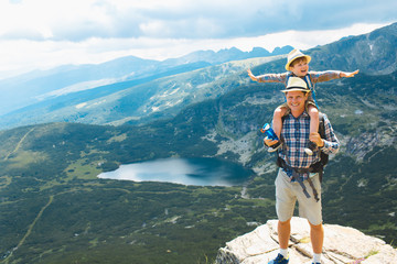 Father and son traveling in Rila mountains Bulgaria