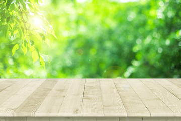 Wall Mural - empty wooden table for product placement or montage with focus to table top in the foreground, with 