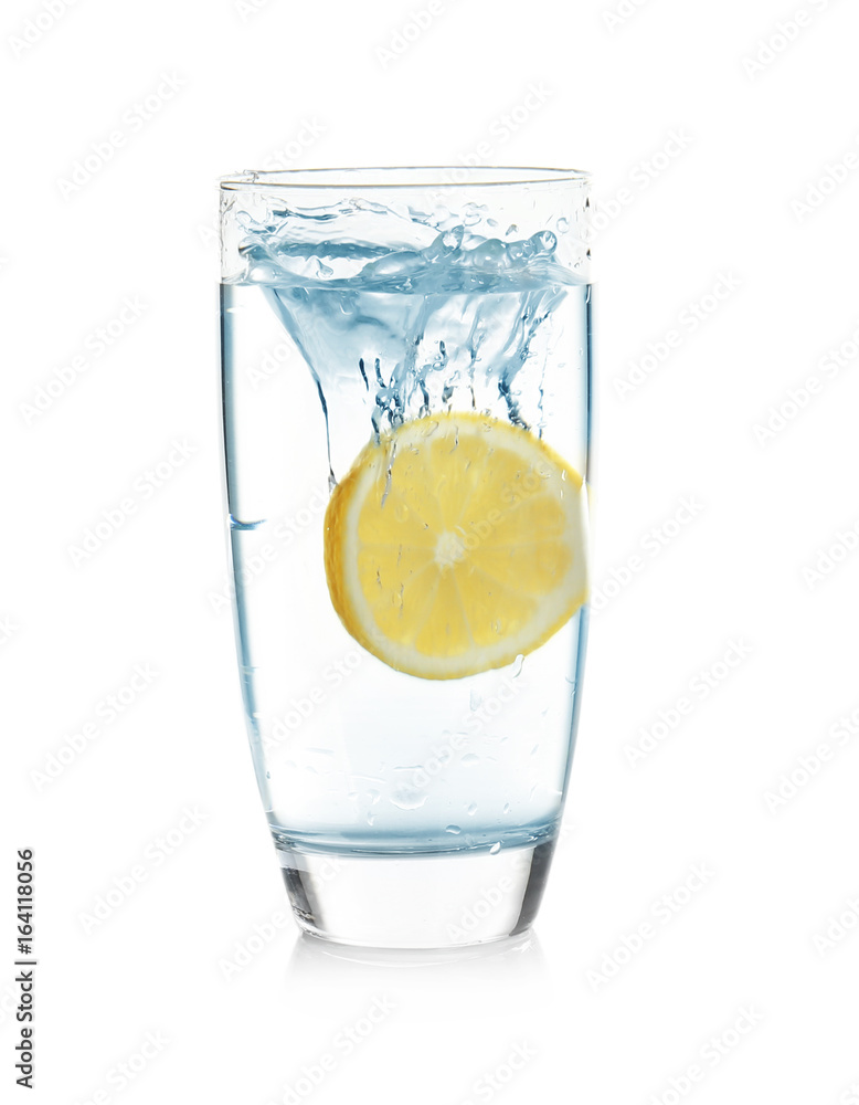 Glass of lemonade with splashing water on white background