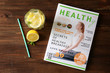 © Africa Studio - Glass of fresh lemonade and magazine on wooden background