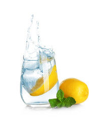 Canvas Print - Glass of lemonade with splashing water on white background