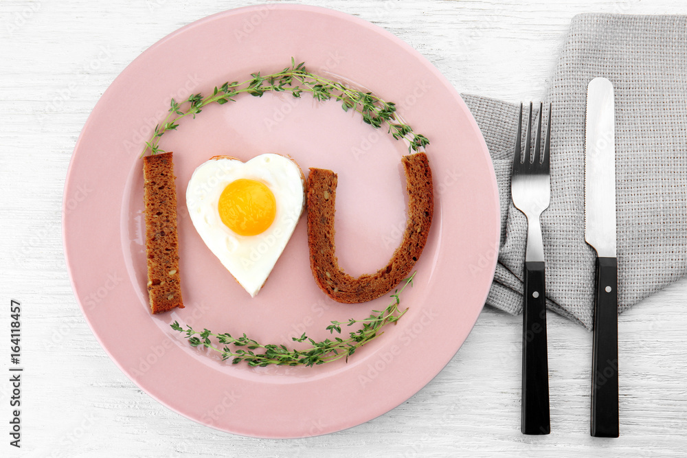 Romantic breakfast with sunny side up egg on table