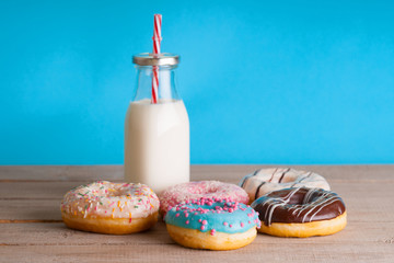 Wall Mural - Baked donuts and glass jar with milk 