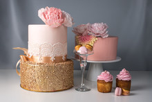 Luxury Wedding Table With A Beautiful Pink Cake Decorated With Mastic Pink Rose And Gold On Gray Background