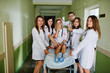 © AS Photo Family - Funny doctors posing on the bed for ill patients in the hospital.