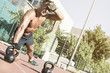 © Addoro - Crossfit training. Fitness man doing a weight training by lifting kettlebell. Midleaged athlete doing kettlebell push ups. Bodybuilder lifting kettlebell. Crossfit instructor at the track.