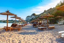 Black Sea Coast, Sand Beach With Sunbeds And Straw Umbrellas, Summer Sea Rest Concept