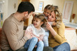 © liderina - Portrait of family having fun in the living room. Happy family spending time at home together.