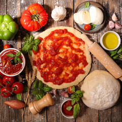 Wall Mural - cooking pizza with tomato sauce,mozzarella and basil