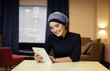 Beautiful Muslim woman with electronic tablet
