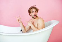 Man With Muscular Body Sitting In White Bathtub
