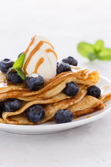 Canvas Print - Crepes served with fresh blueberries, ice cream and caramel sauce