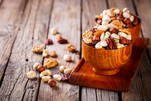 Nuts Mixed In A Wooden Plate.Assortment, Walnuts,Pecan,Almonds,Hazelnuts,Cashews,Pistachios.Concept Of Healthy Eating.Vegetarian.Copy Space.selective Focus.
