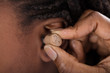 Doctor Inserting Hearing Aid
