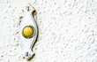 weathered mid century doorbell and plate on house wall