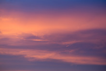 Warm Pink Glow In Cold Blue Sky. Background Empty Blurred. Deep Blue Matte Backdrop. Ruddy Glow.