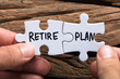 Hands Holding Retire Plan Matching Jigsaw Pieces