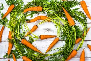 Fresh carrots, flat lay vegetables background