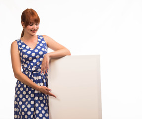 Young happy woman portrait of a confident businesswoman showing presentation, pointing placard background. Ideal for banners, registration forms, presentation, landings, presenting concept.