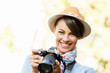 © Sergey Nivens - Outdoor summer smiling lifestyle portrait of pretty young woman with camera
