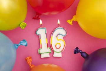 Wall Mural - Happy Birthday number 16 celebration candle with colorful balloons